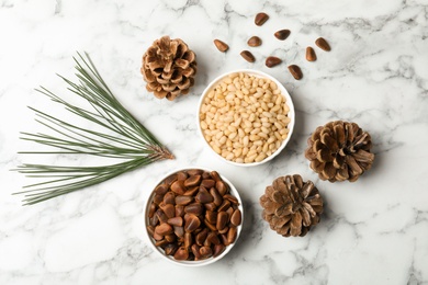Photo of Flat lay composition with pine nuts on marble background