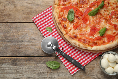 Delicious pizza Margherita on wooden table, flat lay