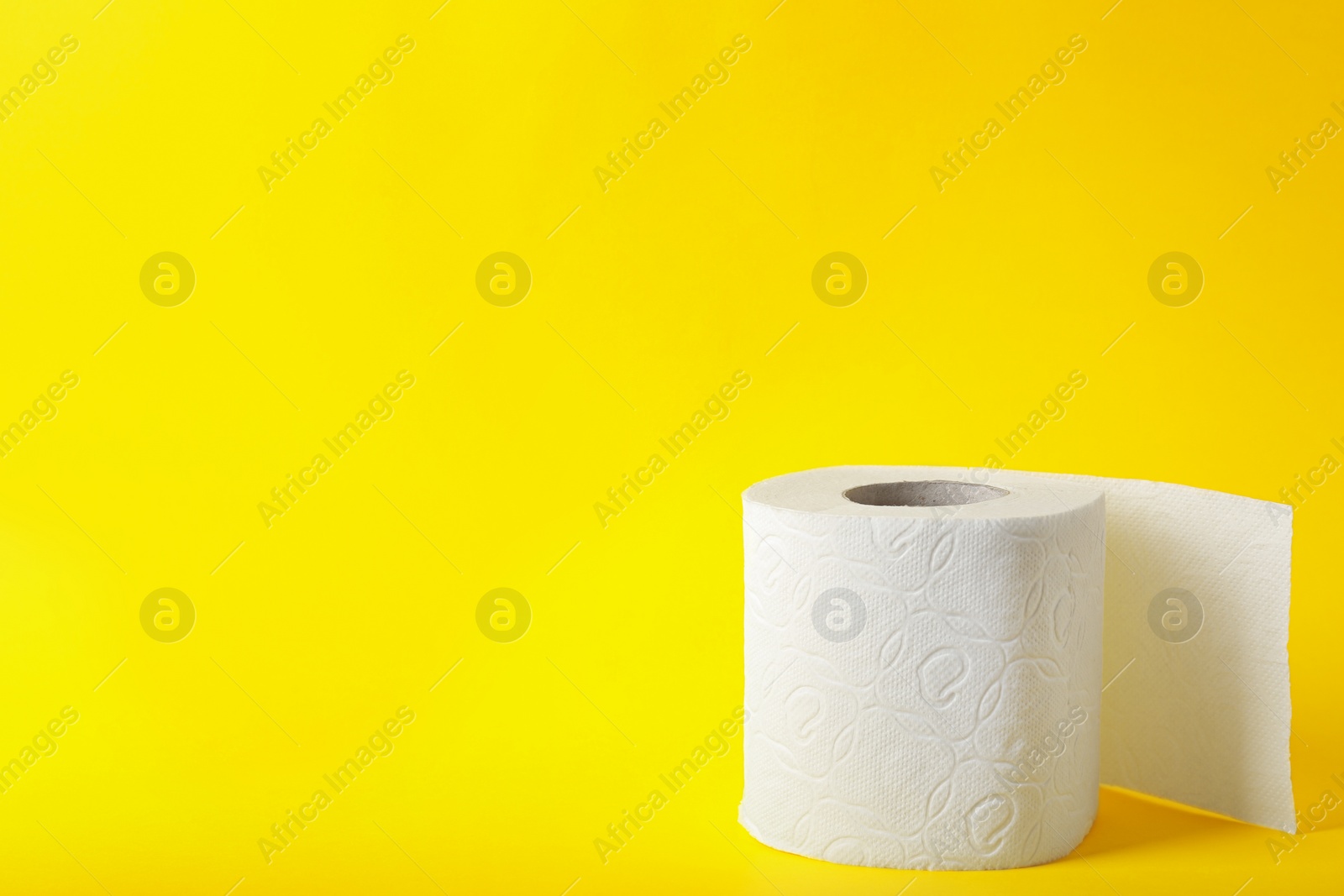 Photo of Roll of toilet paper on color background. Space for text