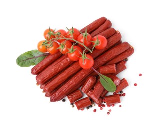 Photo of Delicious smoked sausages, tomatoes, pepper and spinach isolated on white, top view