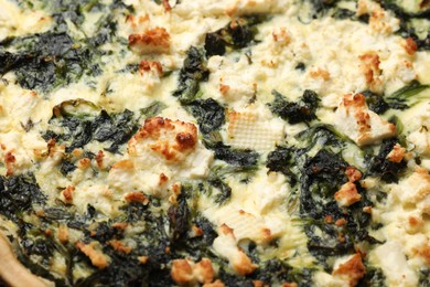 Photo of Delicious homemade spinach quiche as background, closeup