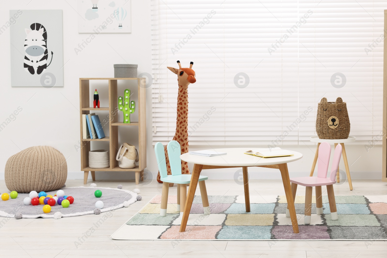 Photo of Stylish kindergarten interior with toys and modern furniture