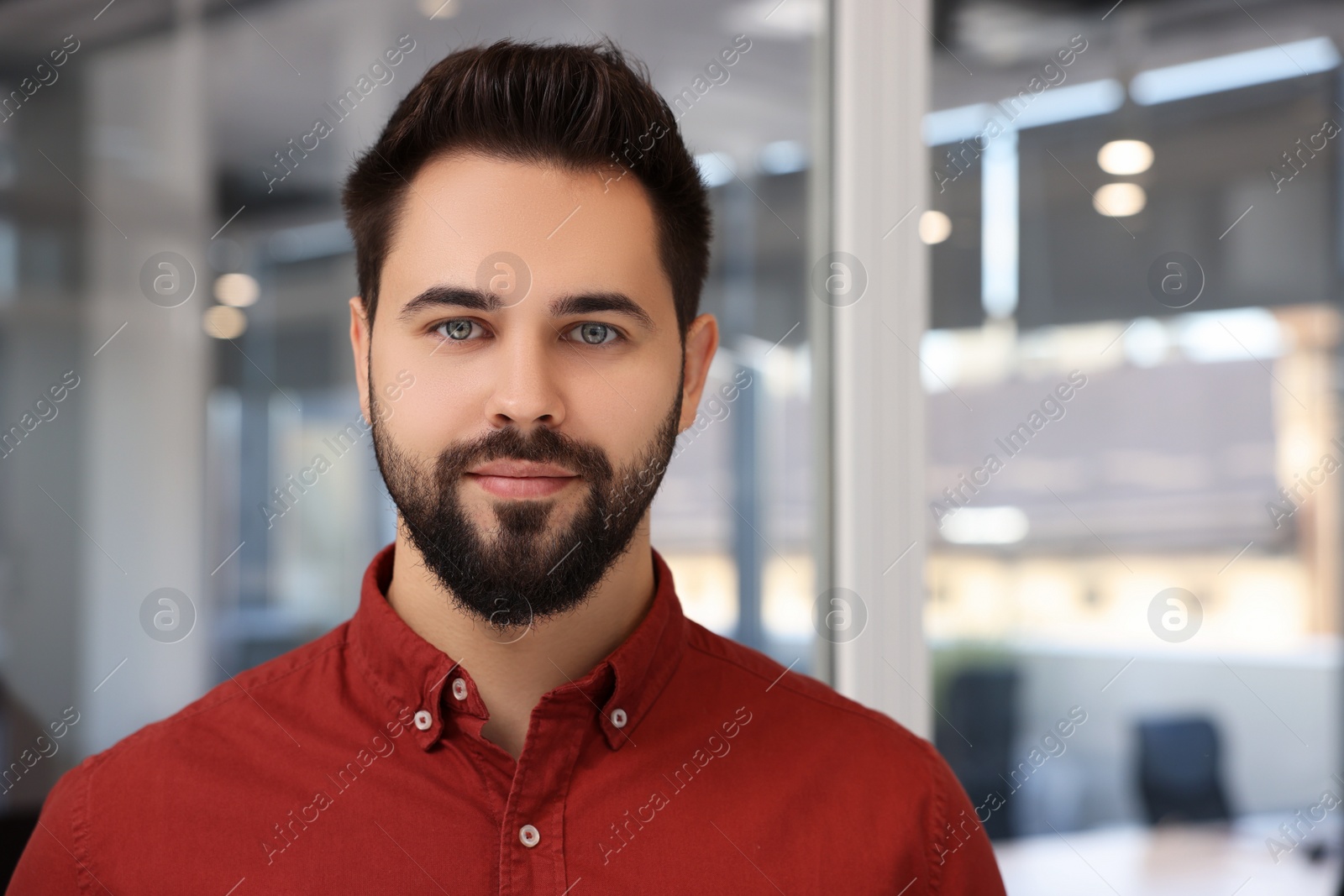 Photo of Portrait of attractive young man on blurred background, space for text