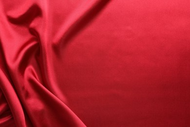 Photo of Texture of beautiful red silk fabric as background, closeup