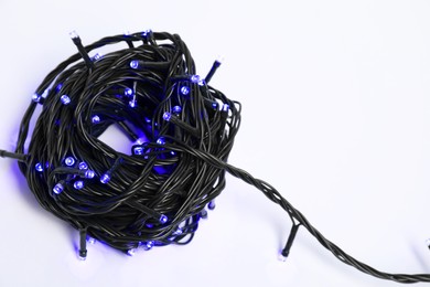 Photo of Bundle of beautiful Christmas lights on white background