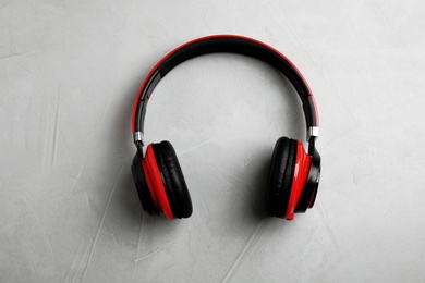 Photo of Stylish modern headphones on gray background, top view