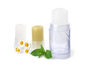 Natural crystal alum stick deodorants with chamomiles and mint on white background