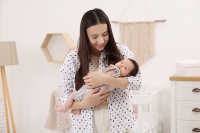 Mother with her cute newborn baby at home