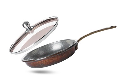 Image of New frying pan and glass lid on white background