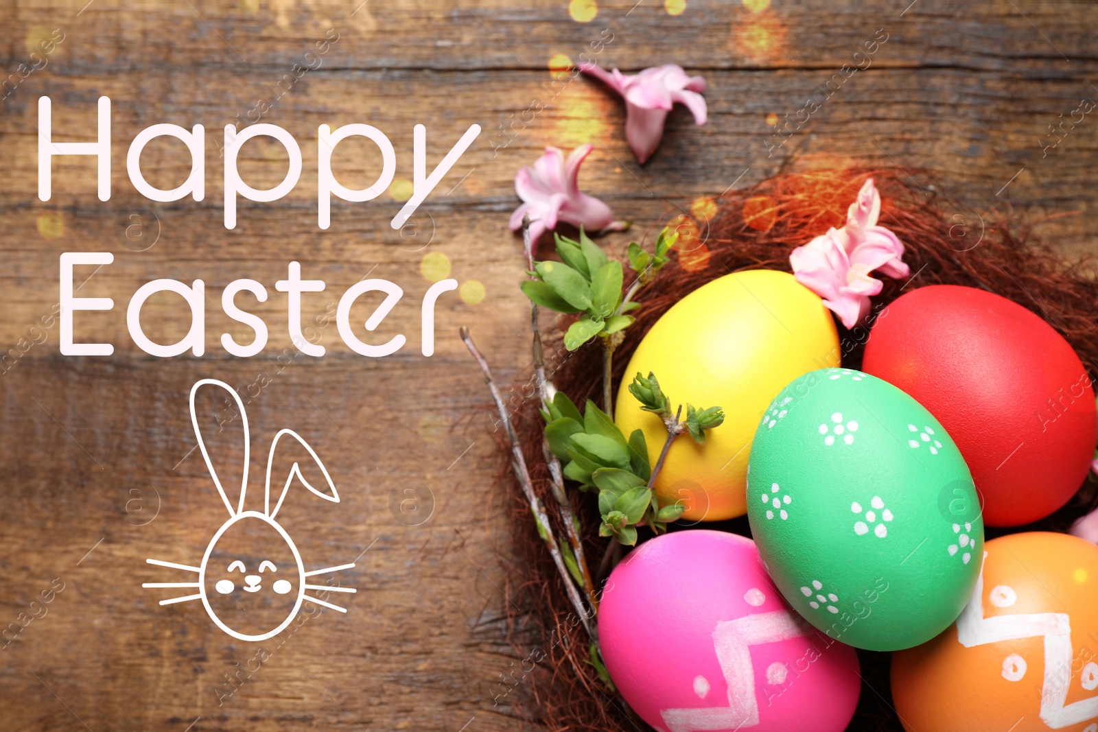 Image of Colorful eggs in decorative nest with flowers and text Happy Easter on wooden background, flat lay 