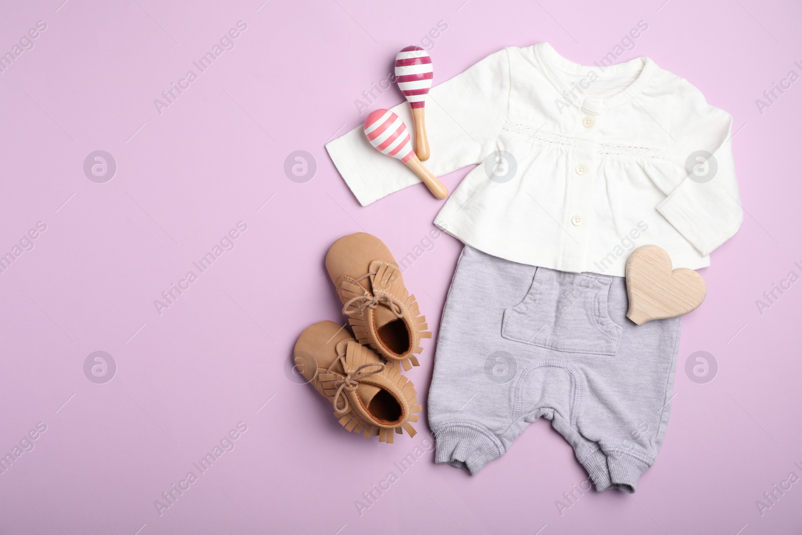 Photo of Flat lay composition with child's clothes on pink background, space for text