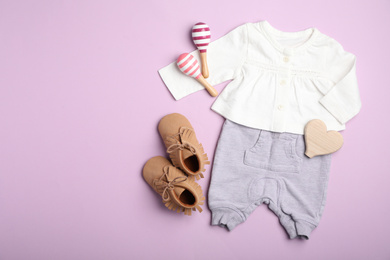 Photo of Flat lay composition with child's clothes on pink background, space for text