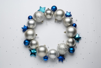 Photo of Beautiful festive wreath made of different Christmas balls on white background, top view