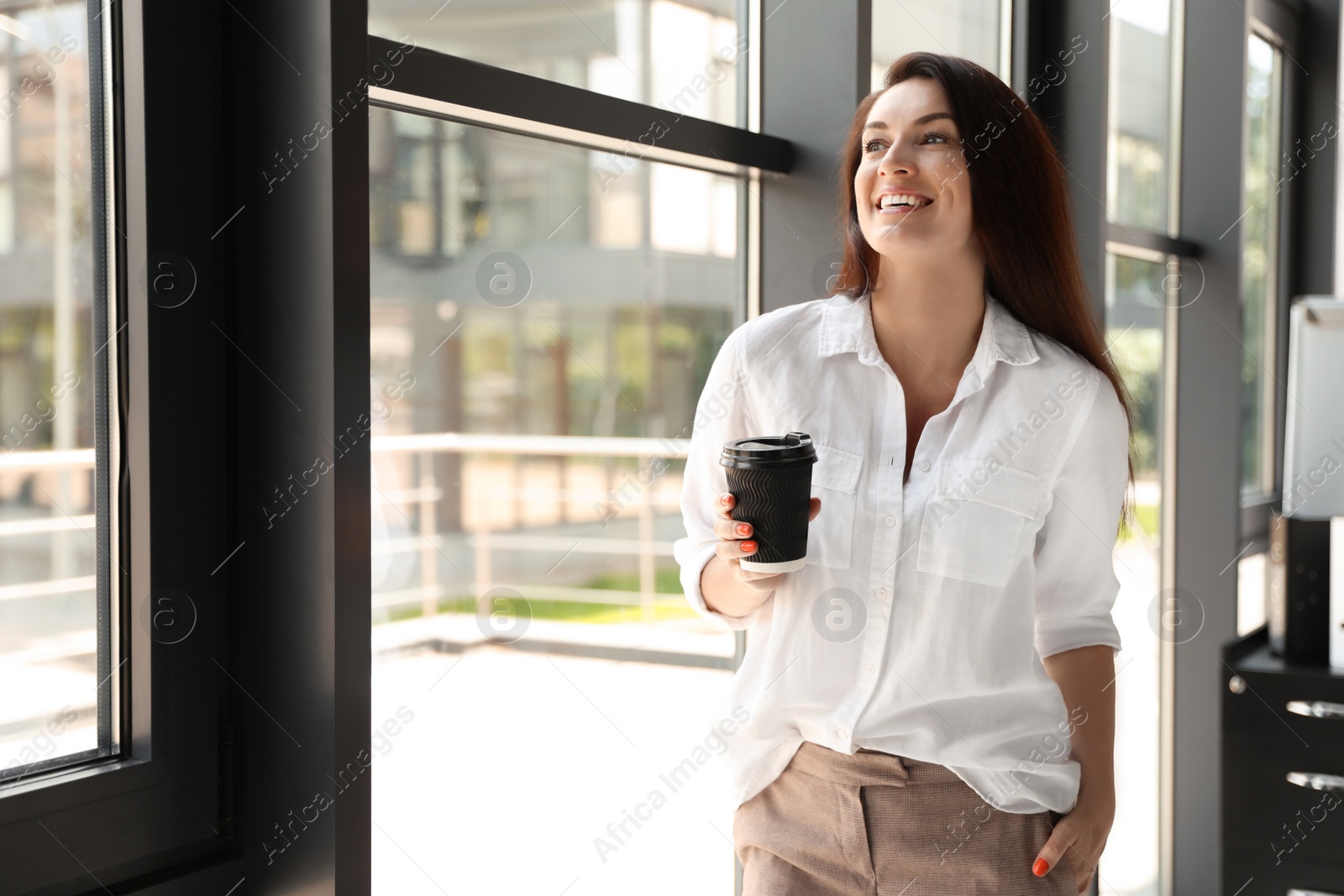 Photo of Portrait of female business trainer with cup of coffee indoors