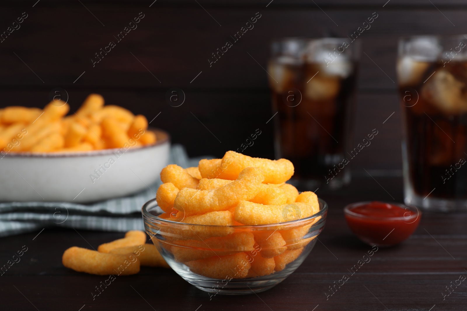 Photo of Crunchy cheesy corn snack on wooden table