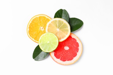 Photo of Slices of fresh ripe citrus fruits and green leaves on white background, flat lay