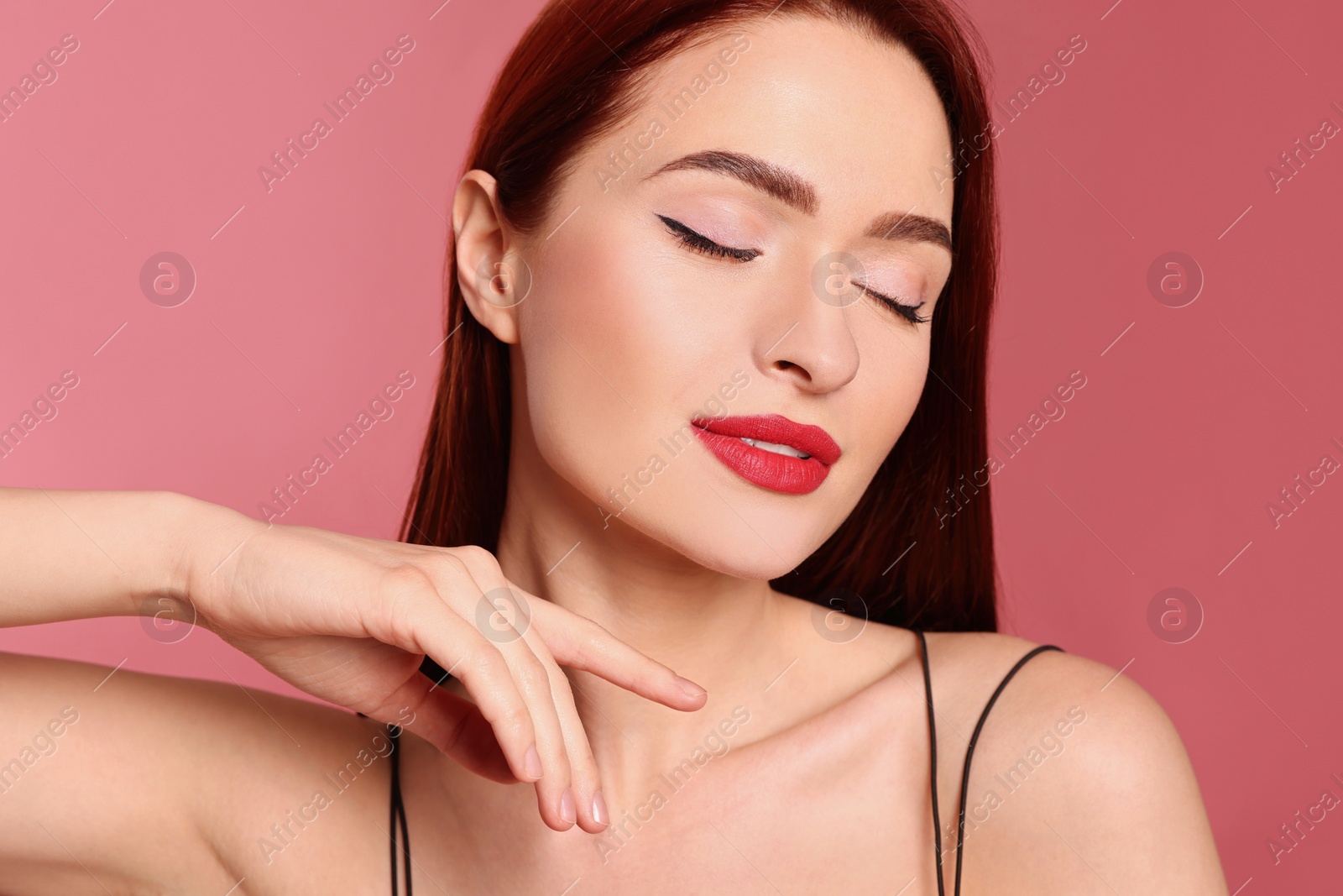 Photo of Beautiful woman with red dyed hair on pink background