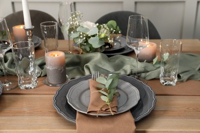 Photo of Festive table setting with beautiful floral decor indoors