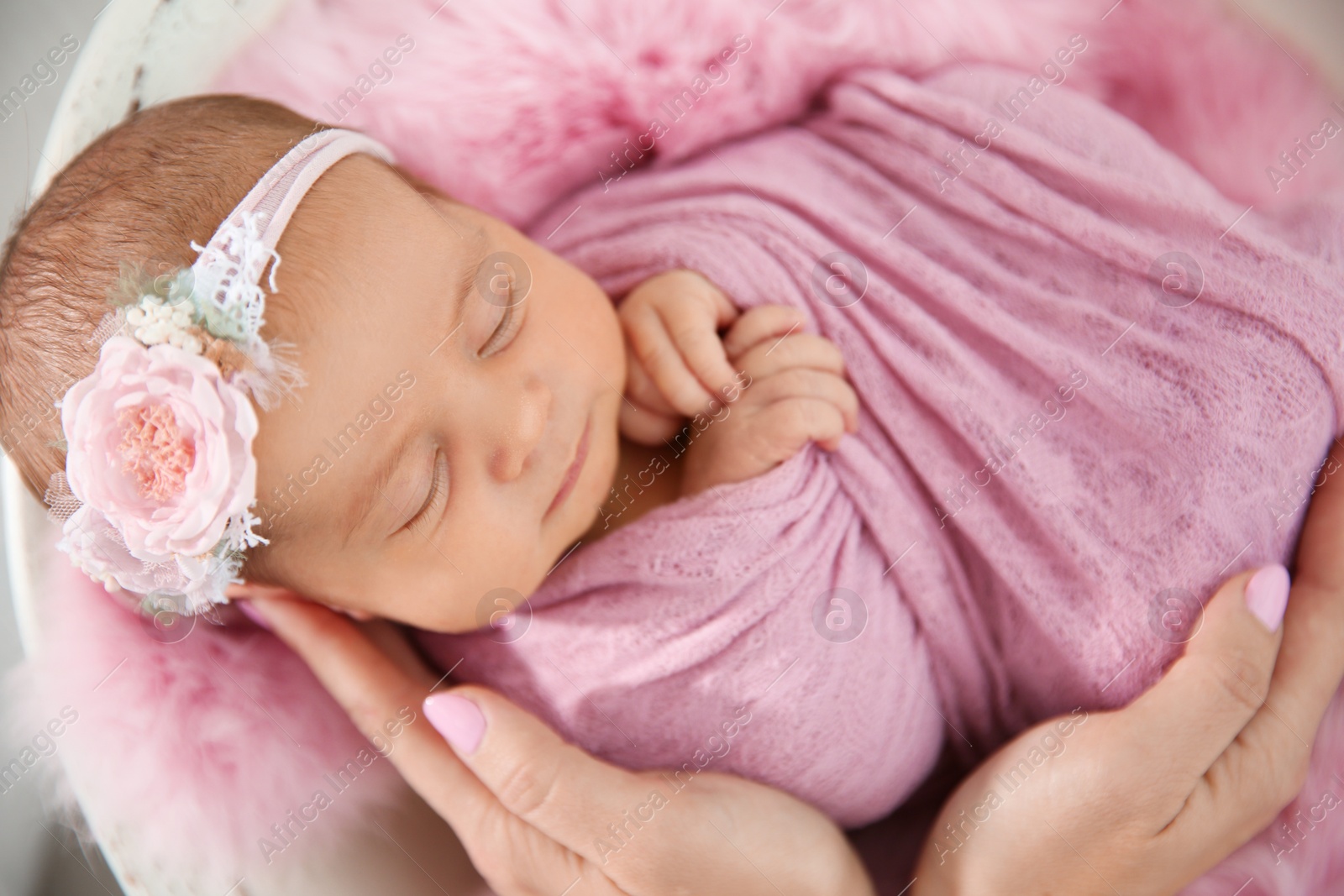 Photo of Cute newborn baby girl with her mother, closeup