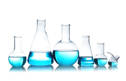 Laboratory glassware for chemical analysis with blue liquid on table against white background