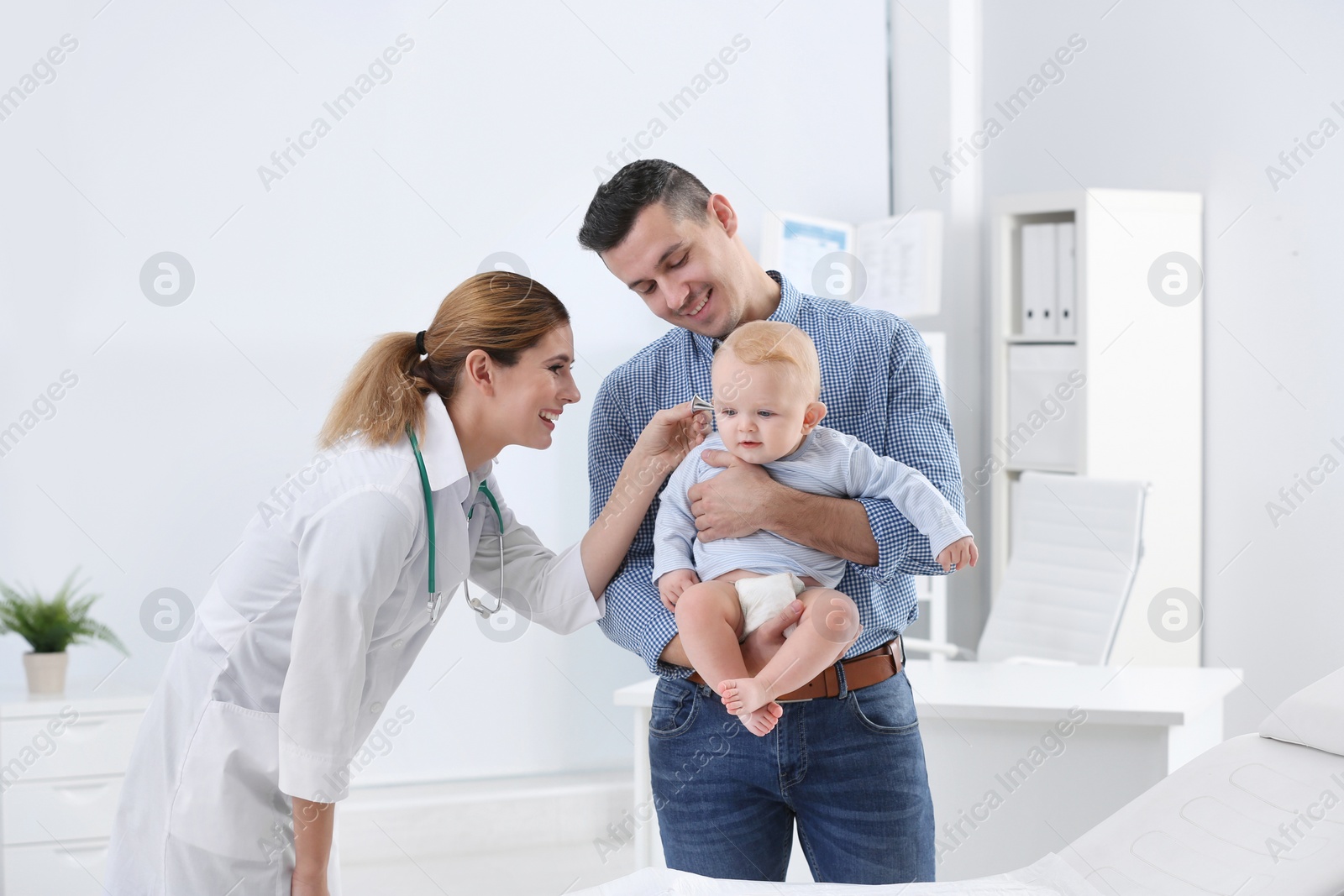 Photo of Man with his baby visiting children's doctor in hospital
