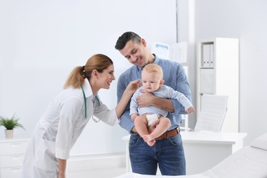 Man with his baby visiting children's doctor in hospital