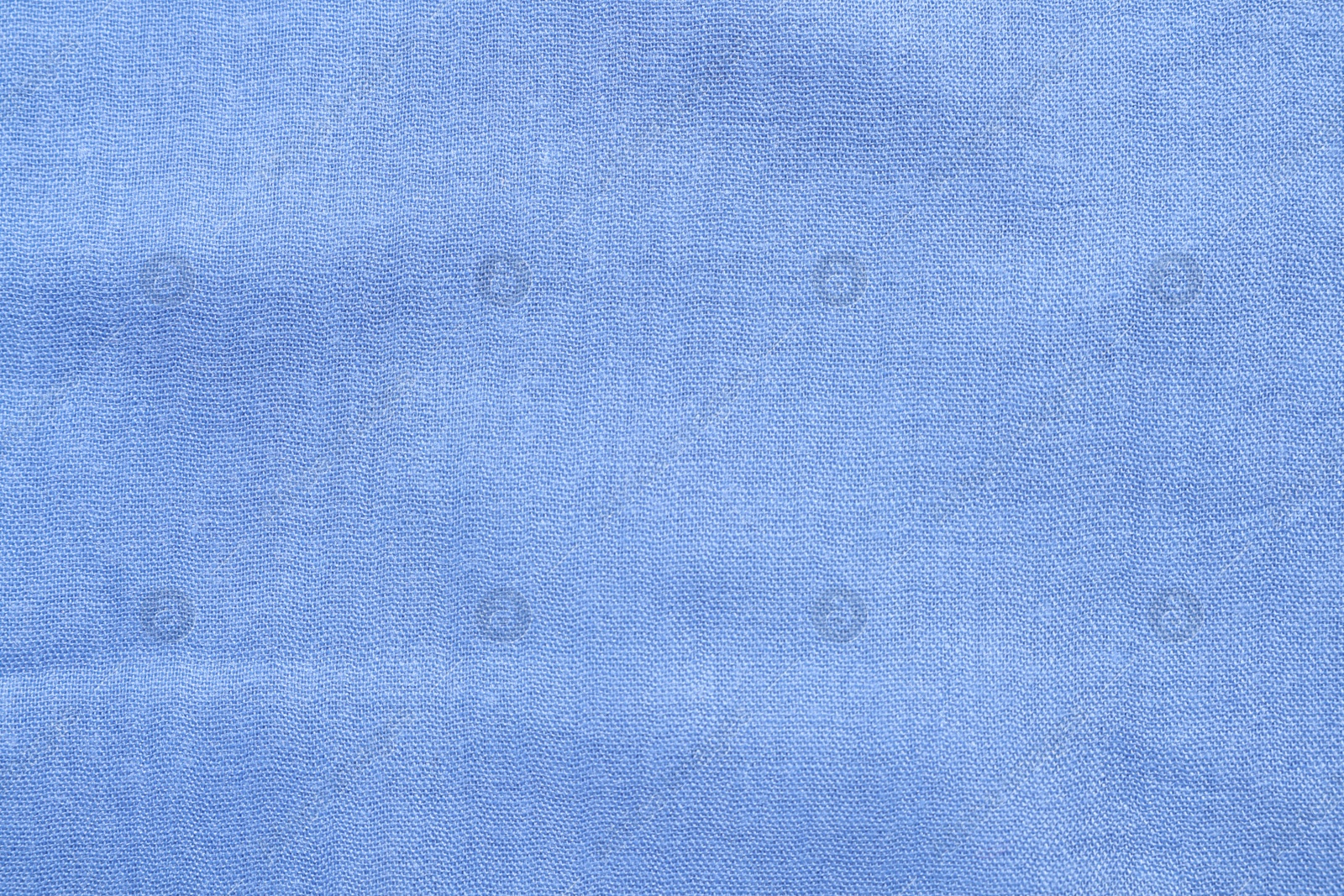 Photo of Texture of light blue fabric as background, top view