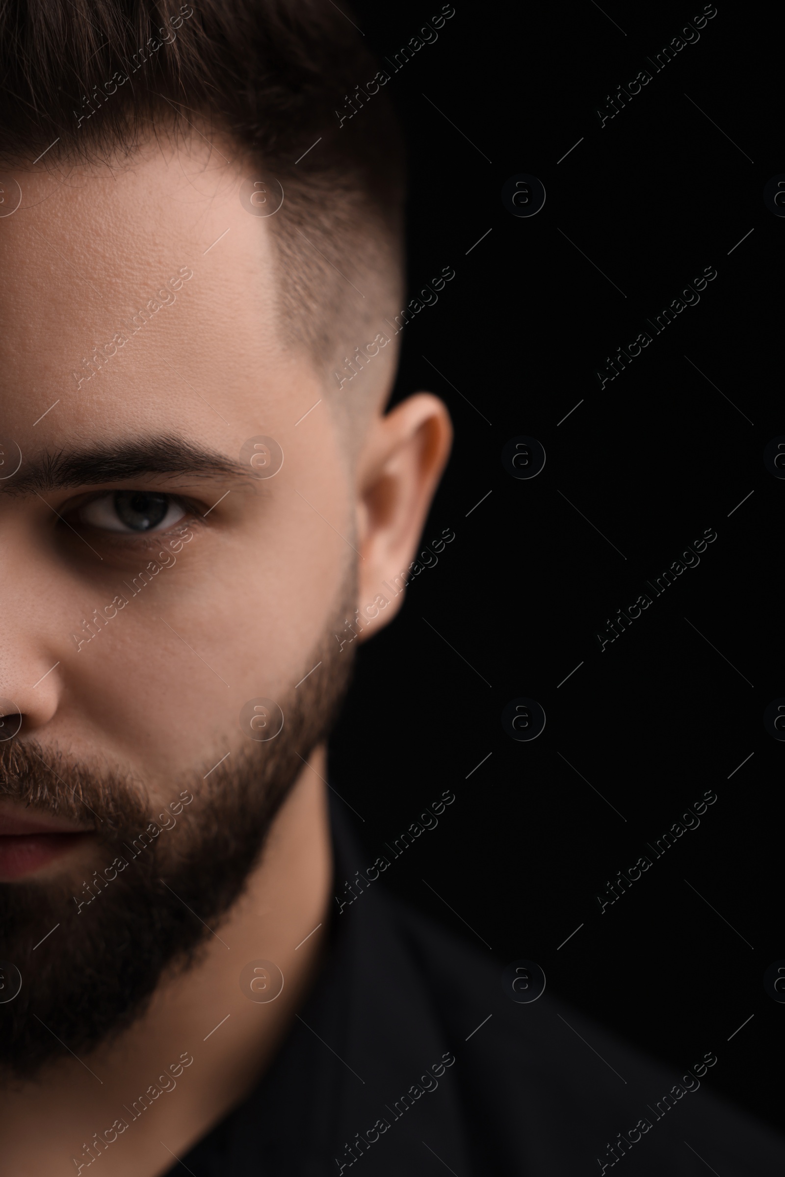 Photo of Evil eye. Man with scary eyes on black background