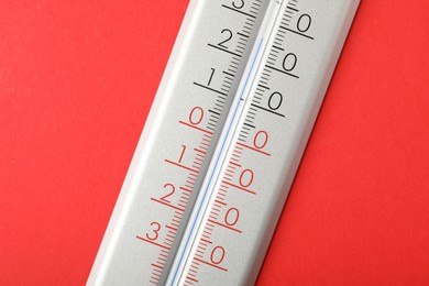 Modern weather thermometer on red background, closeup