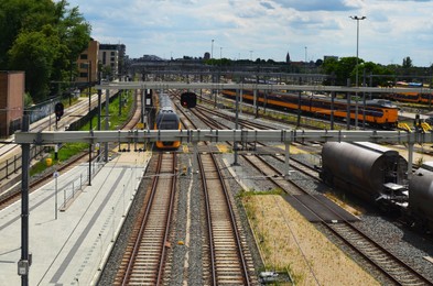 Railway lines and modern trains on sunny day