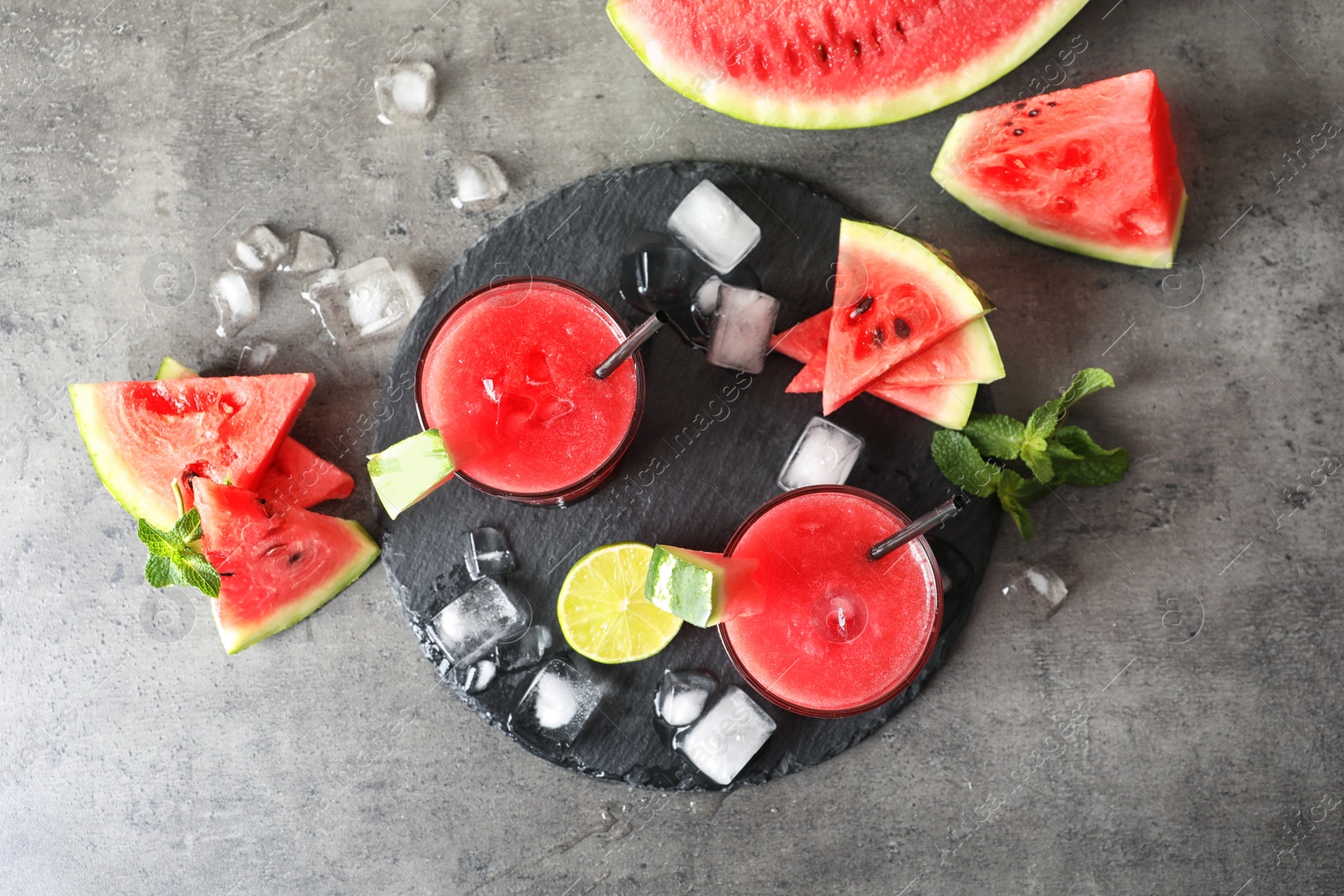 Photo of Tasty summer watermelon drink in glasses served on table, top view