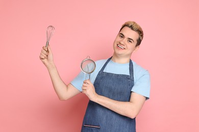 Photo of Portrait of happy confectioner on pink background