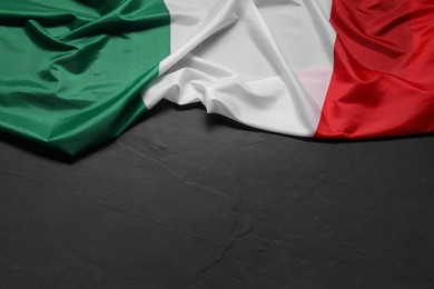 Photo of Flag of Italy on black background, top view. Space for text