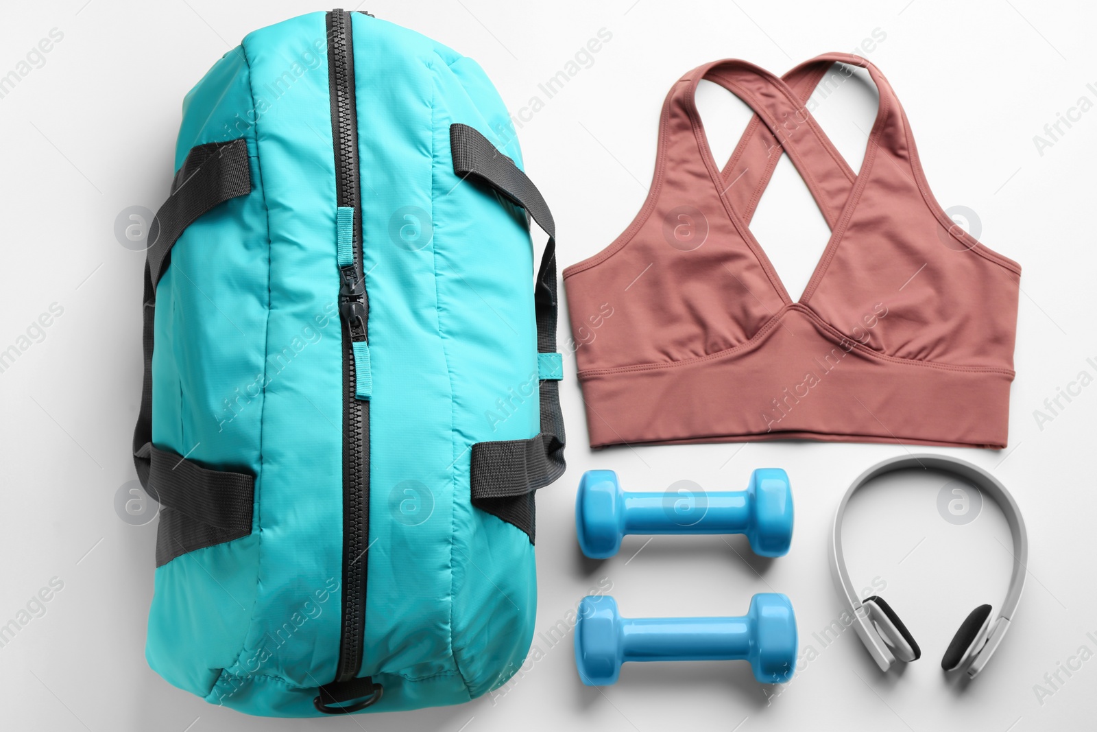 Photo of Flat lay composition with gym bag and sportswear on white background