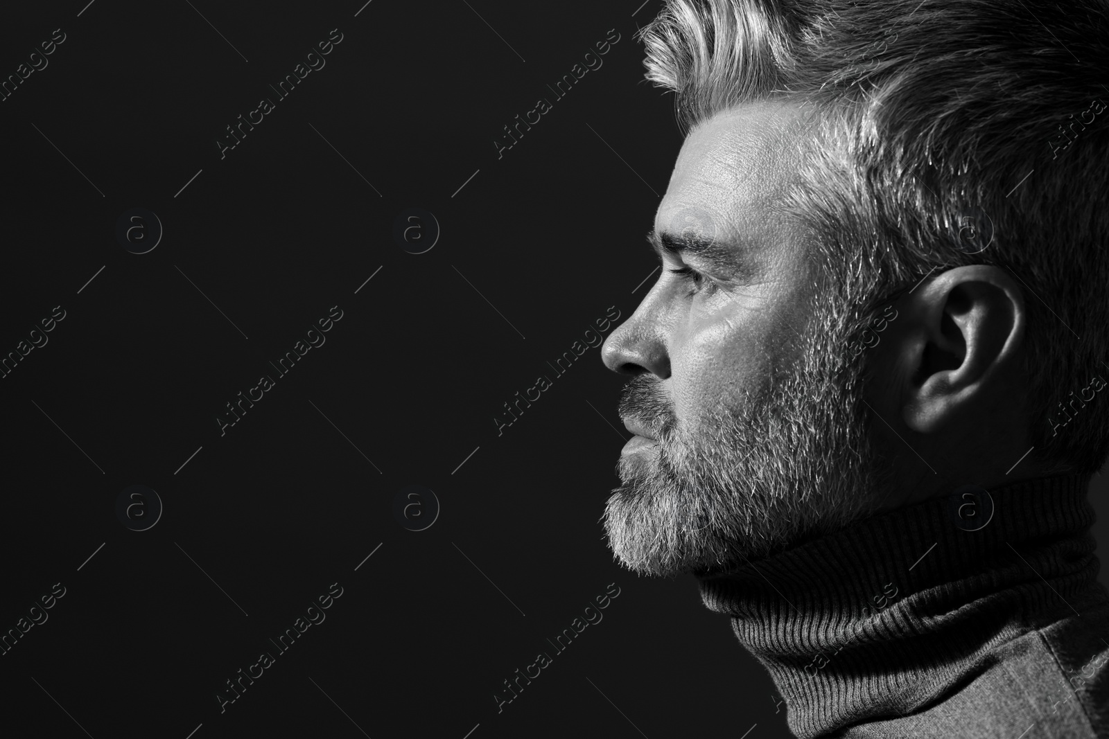 Photo of Portrait of handsome man on dark background, space for text. Black and white effect