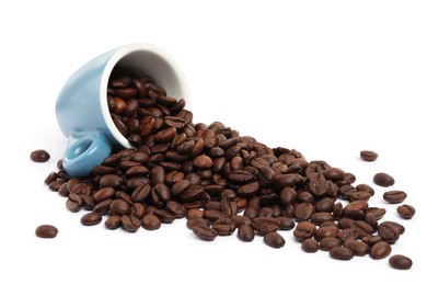 Photo of Coffee beans and overturned light blue cup isolated on white