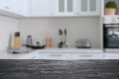 Image of Black wooden table in light kitchen. Space for design