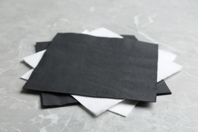 Clean napkins on grey marble table, closeup. Personal hygiene