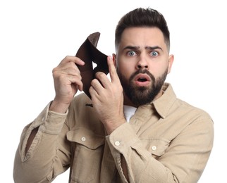 Confused man showing empty wallet on white background