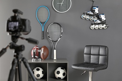 Workplace for blogger with camera and sportive equipment indoors