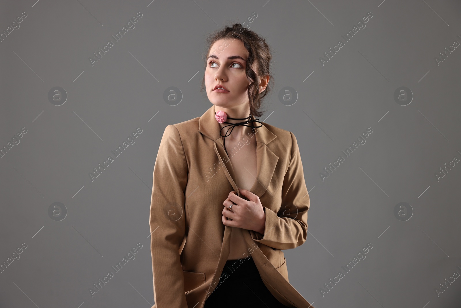 Photo of Portrait of beautiful young woman on grey background