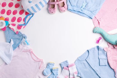 Composition with cute clothes and space for text on white background, flat lay. Baby accessories