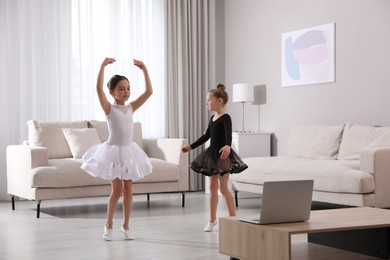 Cute little girls taking online dance class at home