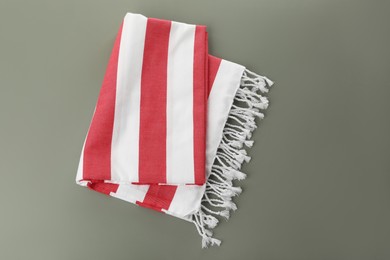 Photo of Folded striped beach towel on grey background, top view