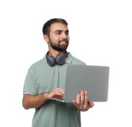 Student with headphones using laptop on white background