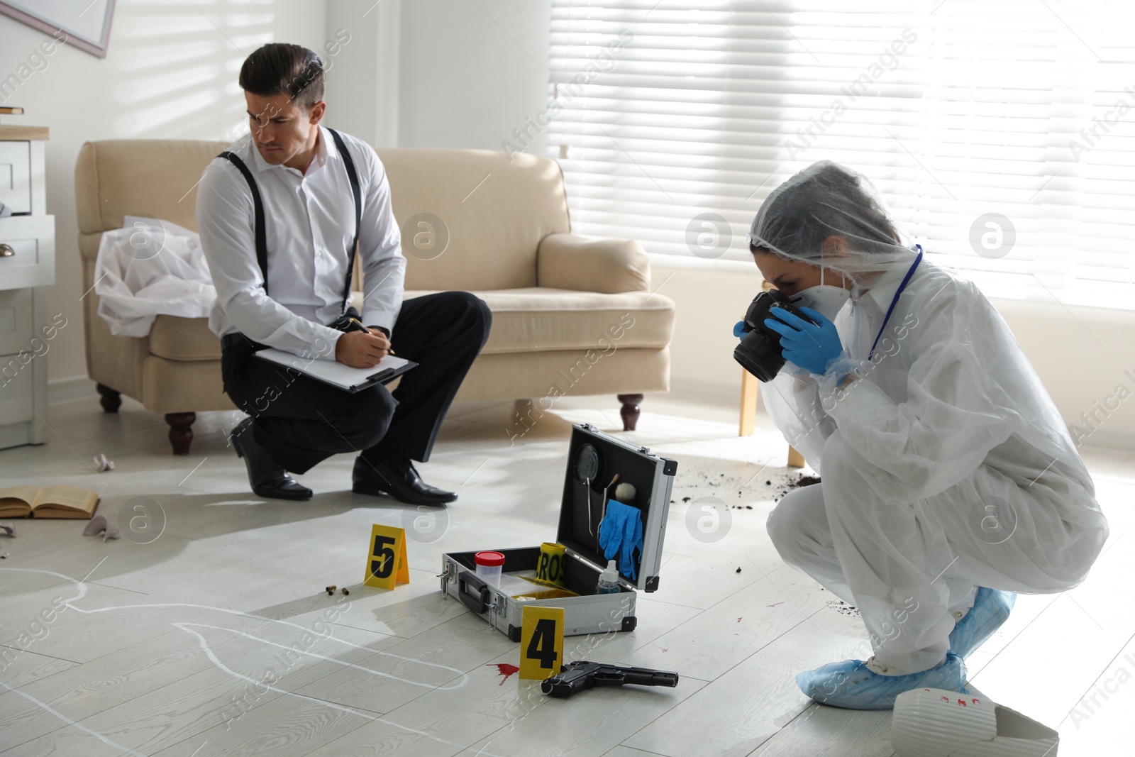 Photo of Investigators working at crime scene in living room