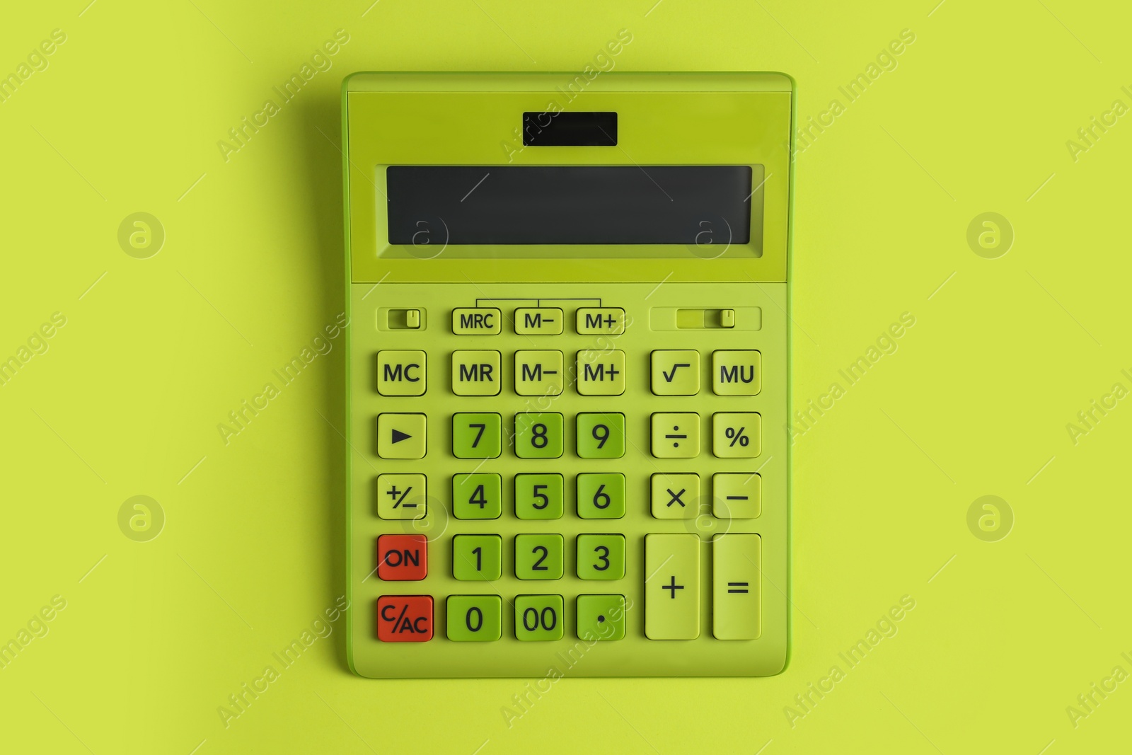 Photo of Modern calculator on green background, top view