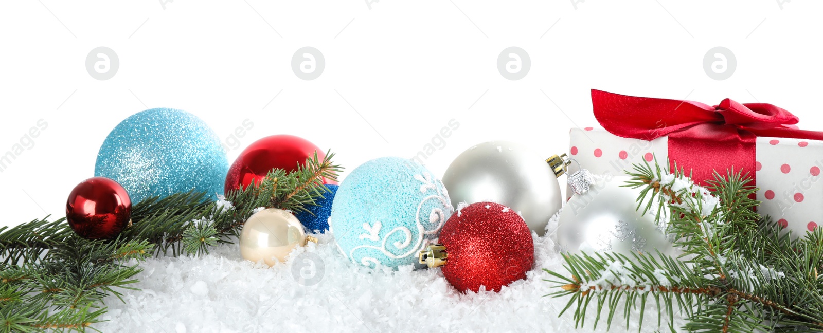 Photo of Christmas decoration with gift box on snow against white background