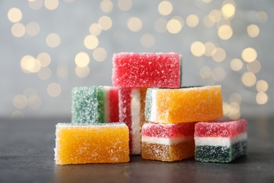 Pile of fruit jelly candies on grey table, closeup