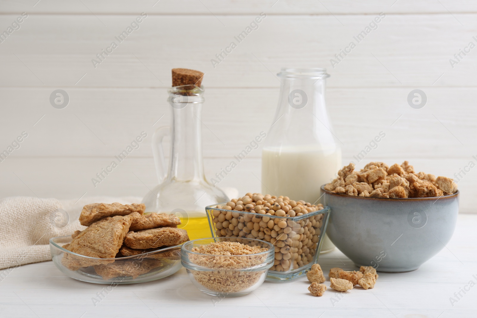 Photo of Different natural soy products on white wooden table